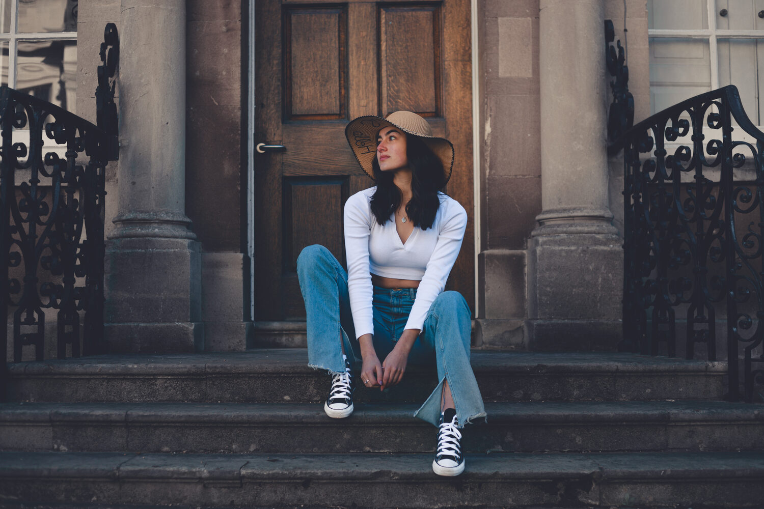 A creator on a KSA Talent shoot, sitting on the steps of a Georgian townhouse